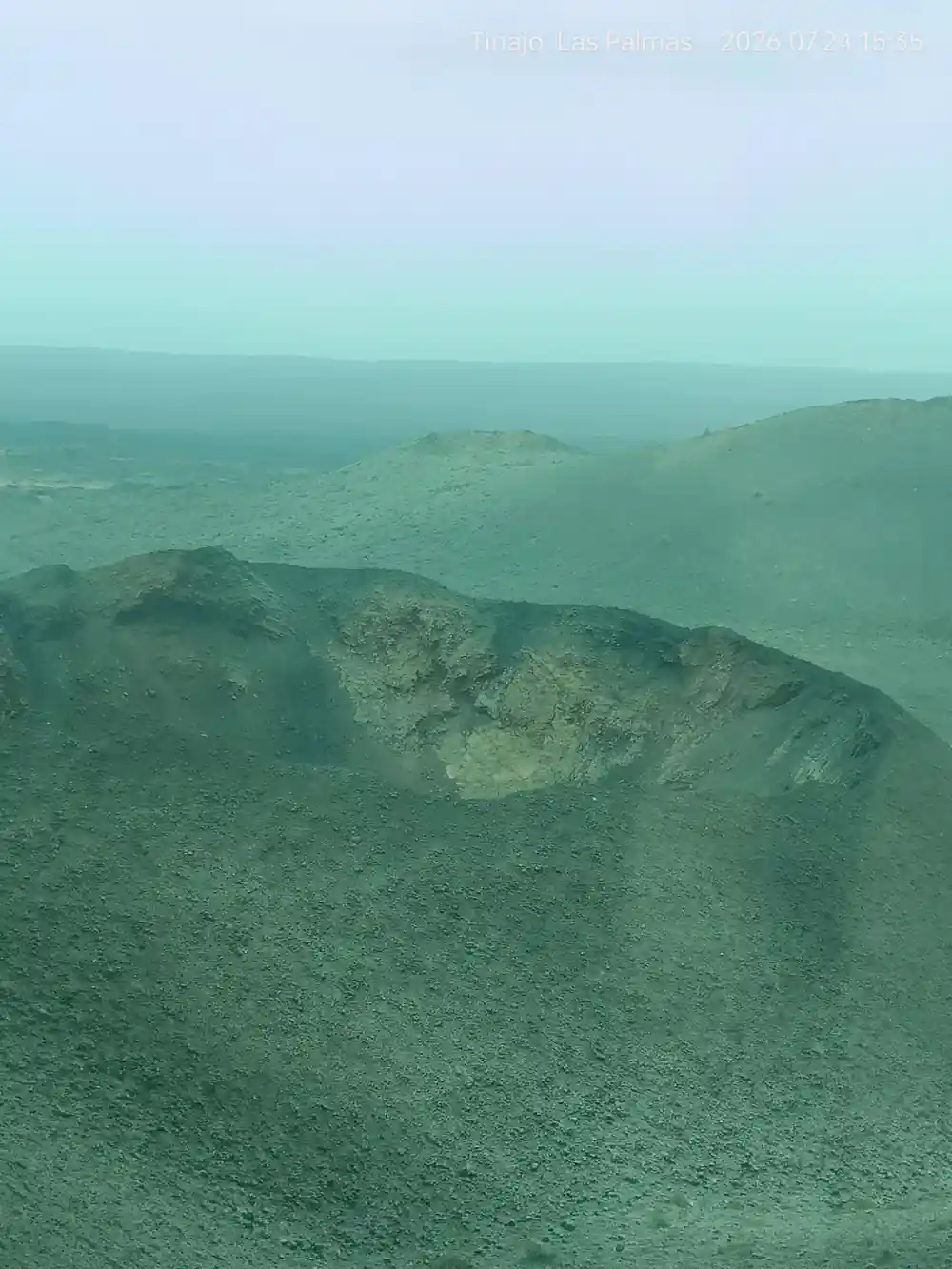 Aerial view of volcanic cones in hazy landscape
