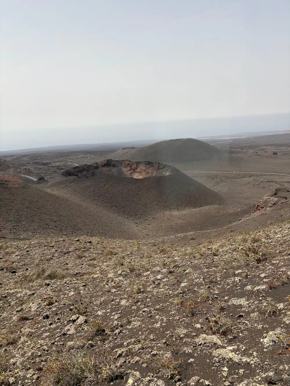 Aerial view of volcanic landscape with multiple dark craters