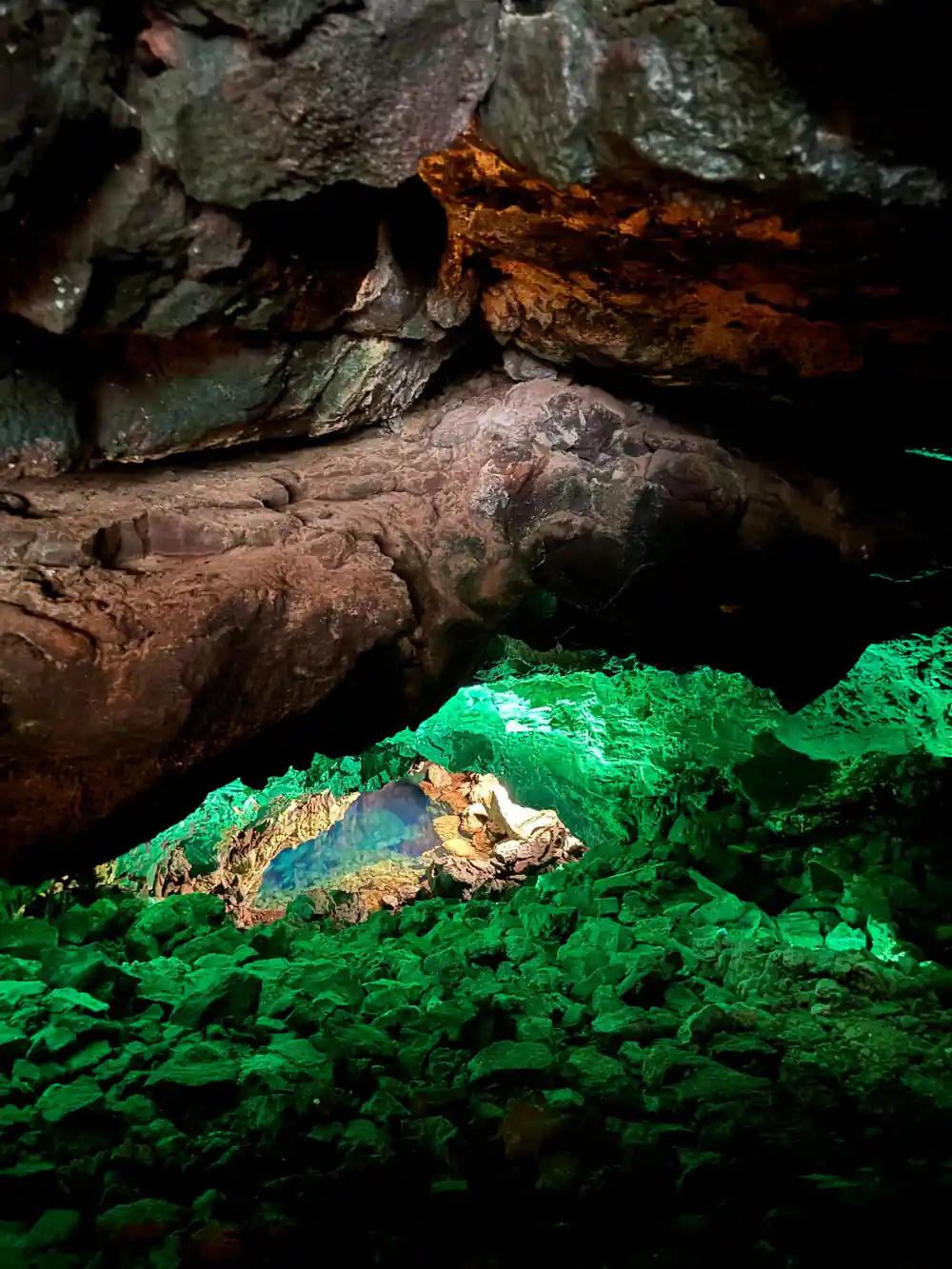 Cave pool with bright green algae and rock formations