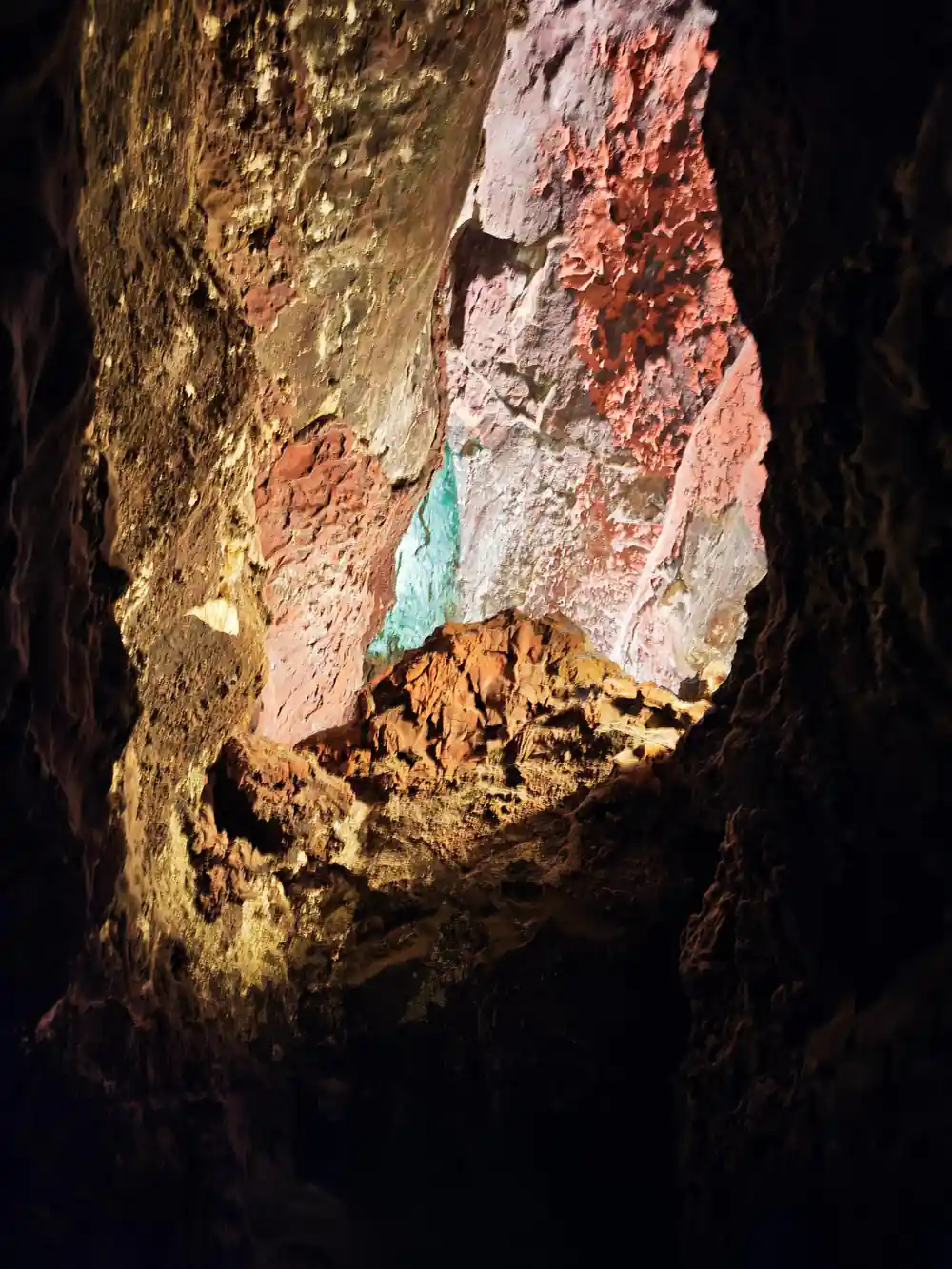 Colorful mineral deposits visible inside cave opening