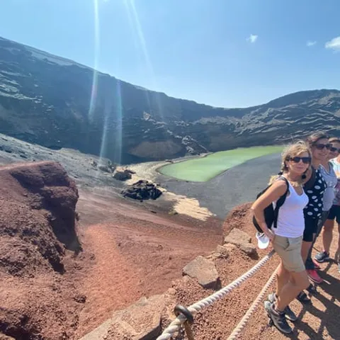 Small group at a viewpoint above the green lagoon