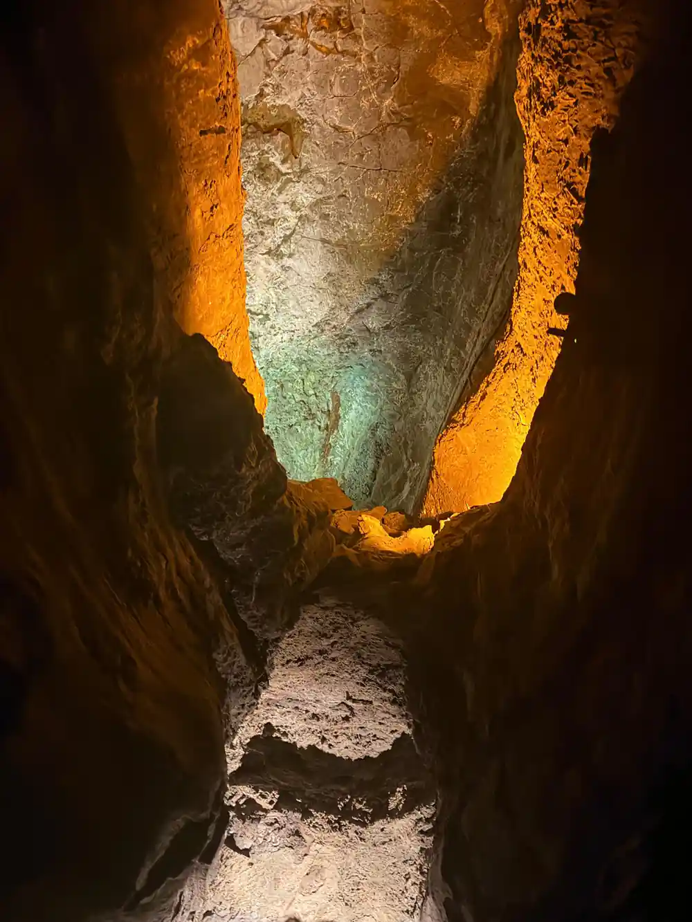 Interior of lava tube with orange and green lighting