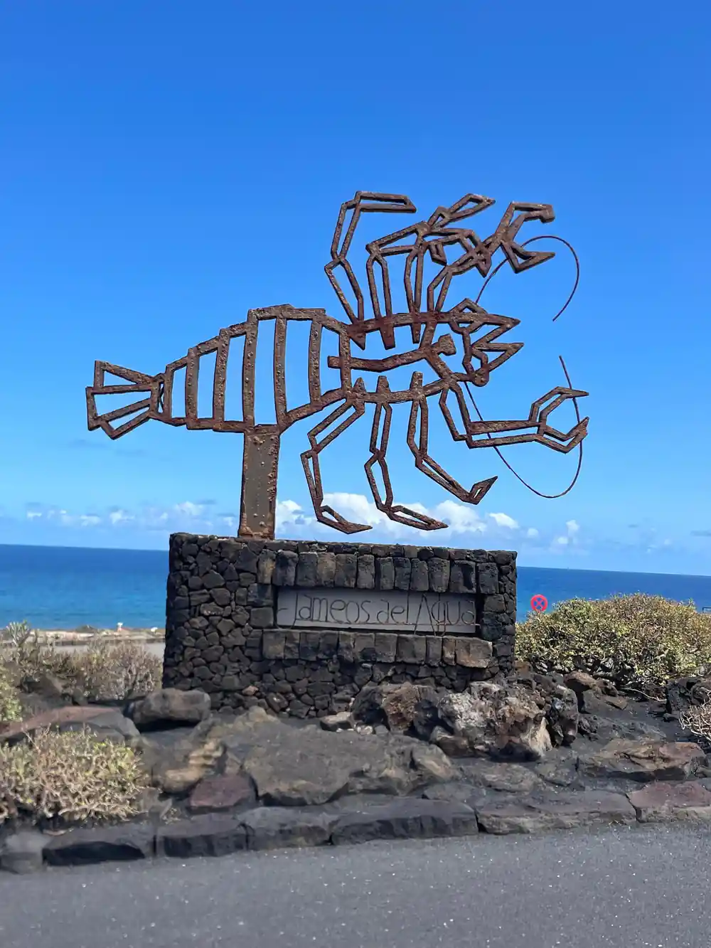Metal octopus sculpture on volcanic rock base