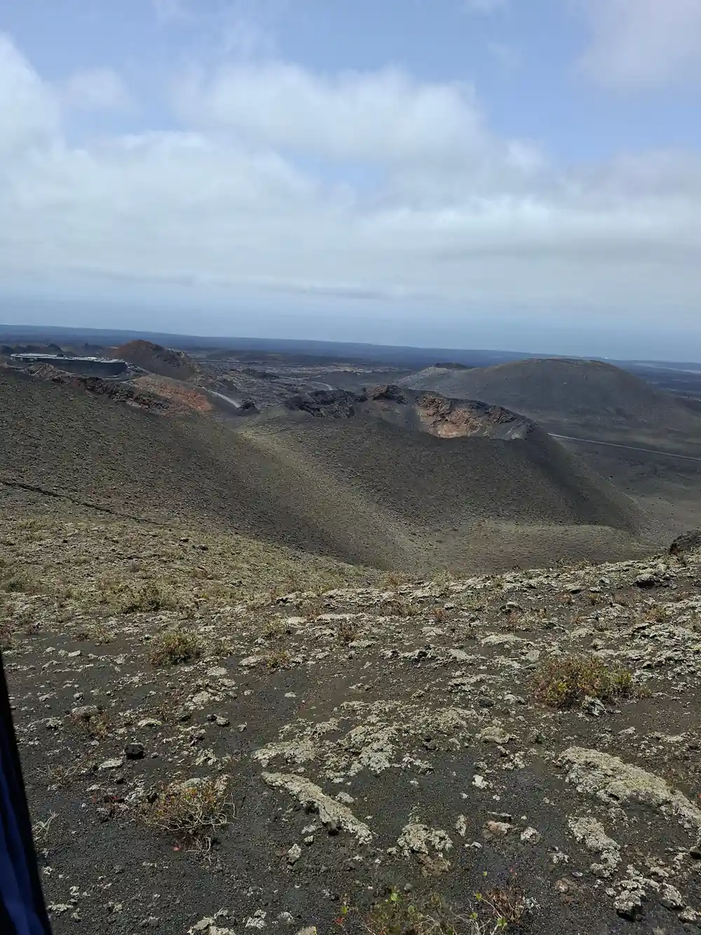 Rocky volcanic crater landscape with ocean horizon visible