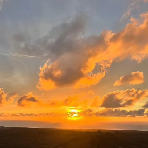 Sunset over dark lava fields and a winding road