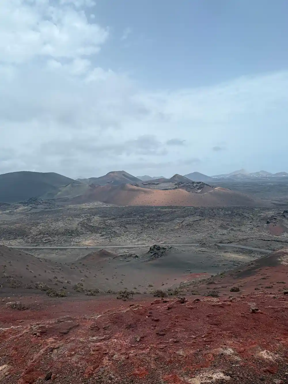 Volcanic cones and crater in expansive arid landscape