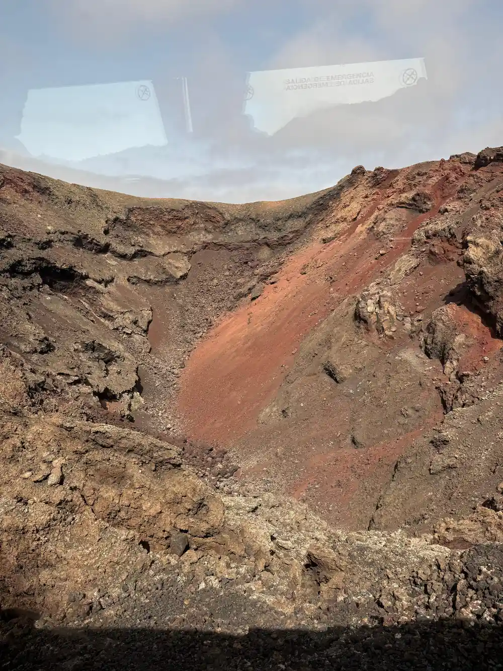 Volcanic crater with red and brown rock layers